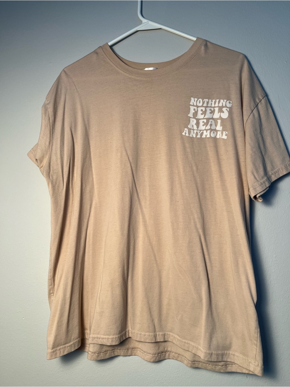 Men's Beige Graphic Tee - "Nothing Feels Real Anymore"